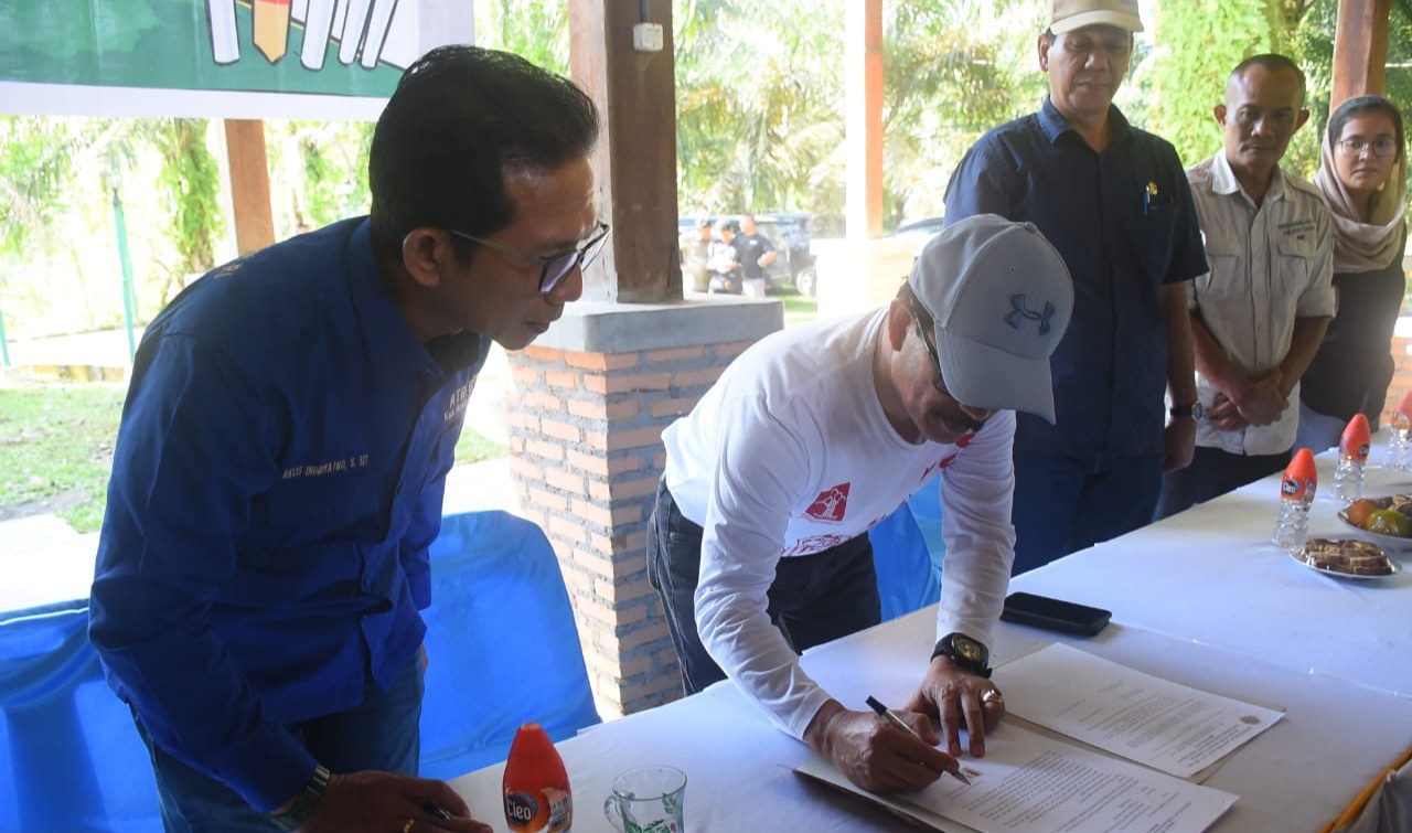 Pj. Bupati Aceh Tamiang Dr. Drs. Meurah Budiman, SH, MH, menandatangani Berita Acara pemasangan patok batas tanah usai pemasangan patok dalam GEMAPATAS di Kawasan Ekowisata Gunung Pandan, Kampung Selamat, Kecamatan Tenggulun.