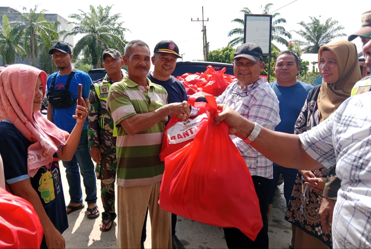 Poto : Pj Bupati Aceh Tamiang Drs. Asra, saat membagikan bantuan 300 paket sembako kepada warga yang terendam banjir di Kampung Gelung Kecamatan Seruway. Minggu (31/12/2023). Dok: Humas/ SWARA45.COM/Afrizal)